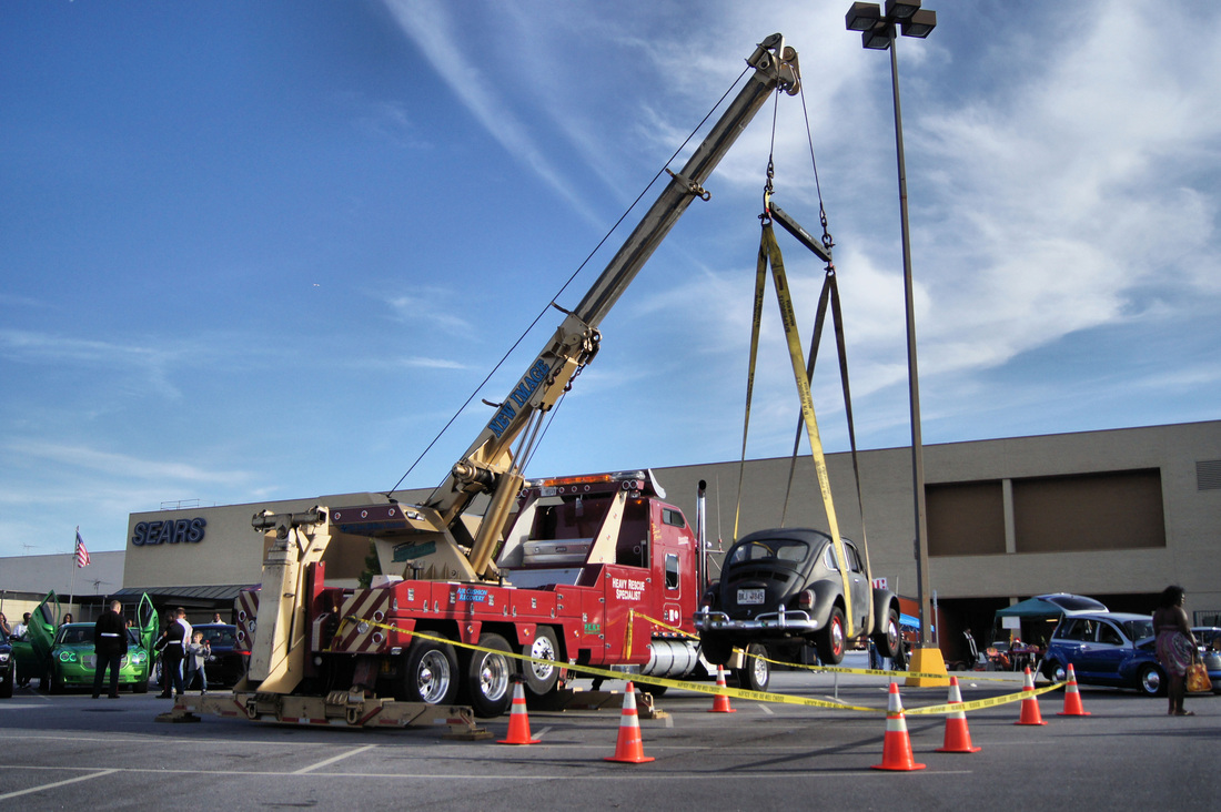 Blog hero image - Volkswagen bug bing lifted by a tow truck